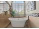 Bright bathroom features a soaking tub, large window, and stylish tile accents at 146 Cedar Woods Trl, Canton, GA 30114