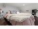 Cozy bedroom featuring soft, natural light, dark wood floors, and a chunky knit blanket at 146 Cedar Woods Trl, Canton, GA 30114