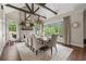 Vaulted dining room with stone fireplace, hardwood floors, and large windows overlooking backyard at 146 Cedar Woods Trl, Canton, GA 30114