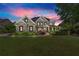 Stately home exterior showcasing manicured lawn, lush landscaping, and elegant architectural details at 146 Cedar Woods Trl, Canton, GA 30114