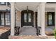 Elegant brick home entryway with double doors and well-manicured landscaping at 146 Cedar Woods Trl, Canton, GA 30114