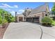 Beautiful brick home with a three-car garage and basketball hoop on a large driveway at 146 Cedar Woods Trl, Canton, GA 30114