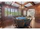 Elegant game room features coffered ceiling, dark wood paneling, oversized windows with shutters and chandelier at 146 Cedar Woods Trl, Canton, GA 30114