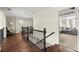Upstairs hallway with hardwood floors, chair railing and views into the living room and staircase at 146 Cedar Woods Trl, Canton, GA 30114