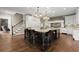 Spacious kitchen features a center island with seating, white cabinets and stainless appliances at 146 Cedar Woods Trl, Canton, GA 30114