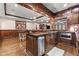 Elegant kitchen and bar with custom cabinetry and hardwood floors at 146 Cedar Woods Trl, Canton, GA 30114