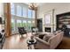 Bright living room features large windows, fireplace, chandelier, and hardwood floors at 146 Cedar Woods Trl, Canton, GA 30114
