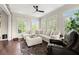 Cozy living room with large windows, plush seating, and a ceiling fan at 146 Cedar Woods Trl, Canton, GA 30114