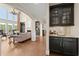 Bright living room with hardwood floors, large windows, and built-in bar with granite countertop at 146 Cedar Woods Trl, Canton, GA 30114