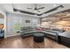 Spacious living room with a large gray sectional, hardwood floors, and custom wood accent wall at 146 Cedar Woods Trl, Canton, GA 30114