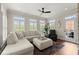 Bright living room with a plush sectional sofa, an ottoman, large windows with plantation shutters, and access to outdoor deck at 146 Cedar Woods Trl, Canton, GA 30114