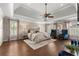 Spacious main bedroom boasts hardwood floors, tray ceilings, fireplace and large windows with natural light at 146 Cedar Woods Trl, Canton, GA 30114