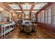 Executive office featuring wood paneling, built-in bookshelves, fireplace, and ample natural light at 146 Cedar Woods Trl, Canton, GA 30114