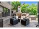Outdoor brick fireplace with seating area and built-in grill perfect for entertaining guests at 146 Cedar Woods Trl, Canton, GA 30114