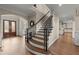 Beautiful curved staircase and foyer with wood floors lead to a well-lit area at 146 Cedar Woods Trl, Canton, GA 30114