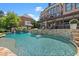 Stunning swimming pool with a stone waterfall and outdoor seating and lounge areas at 146 Cedar Woods Trl, Canton, GA 30114