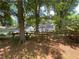 Backyard featuring mature trees that provide shade and privacy, along with a rustic wooden fence at 212 South Se Ave, Marietta, GA 30060