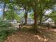 Picturesque view of the home's backyard highlighting mature trees and a classic wooden fence at 212 South Se Ave, Marietta, GA 30060