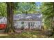 The backyard features a tree and an exterior view of the house with a gray roof at 212 South Se Ave, Marietta, GA 30060