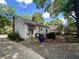 Backyard showcasing a covered area, outdoor storage, and lush trees, creating a private and peaceful outdoor space at 212 South Se Ave, Marietta, GA 30060