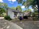 Backyard view with covered area, outdoor storage, and mature trees, perfect for outdoor activities and enjoying nature at 212 South Se Ave, Marietta, GA 30060