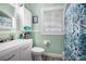 The bathroom has a toilet, shower and tub combination, vanity, and a mirror at 212 South Se Ave, Marietta, GA 30060