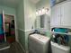 The bathroom features a neutral vanity, a framed mirror, and a shower with curtain at 212 South Se Ave, Marietta, GA 30060