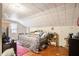 This bedroom features one window, off-white walls, and a queen bed with a gray comforter at 212 South Se Ave, Marietta, GA 30060