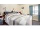 This bedroom features one window, light yellow walls, and a queen bed with a gray comforter at 212 South Se Ave, Marietta, GA 30060