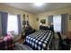 Comfortable bedroom with natural light, a black and white checkered bedspread and guitar decor at 212 South Se Ave, Marietta, GA 30060