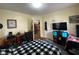 Comfortable bedroom with a desk, work chair, and a black and white checkered bedspread at 212 South Se Ave, Marietta, GA 30060