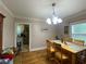 Bright dining room featuring hardwood floors, a chandelier, and an open view into the kitchen at 212 South Se Ave, Marietta, GA 30060