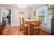 Dining room with hardwood floors, a wooden table with seating, and a large window at 212 South Se Ave, Marietta, GA 30060