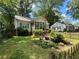 Quaint home with a welcoming screened porch and shuttered windows, enhanced by a charming garden and picket fence at 212 South Se Ave, Marietta, GA 30060