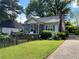 Charming single-story home with a screened-in porch, light-colored siding, and a well-manicured front yard at 212 South Se Ave, Marietta, GA 30060
