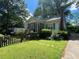 Charming single-story home with a screened-in porch, light-colored siding, and a well-manicured front yard at 212 South Se Ave, Marietta, GA 30060