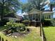 Charming home featuring a screened porch and blue shutters, complemented by a beautiful landscaped garden and picket fence at 212 South Se Ave, Marietta, GA 30060