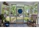 Relaxing screened porch with rocking chair, plants, and classic decor at 212 South Se Ave, Marietta, GA 30060