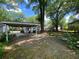 View of the front yard and driveway with a carport attached to the charming white house at 212 South Se Ave, Marietta, GA 30060