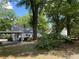 Scenic view of the home's front yard with mature trees and a carport; well-maintained landscape at 212 South Se Ave, Marietta, GA 30060