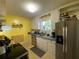 Bright kitchen with stainless steel refrigerator, white cabinets and natural light from the backyard window at 212 South Se Ave, Marietta, GA 30060