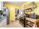 Kitchen featuring open shelving, tile floors, stainless steel appliances, and yellow walls at 212 South Se Ave, Marietta, GA 30060