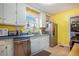 Kitchen with stainless steel appliances, tile floors, and white cabinets at 212 South Se Ave, Marietta, GA 30060