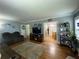 Spacious living room with hardwood floors, a large TV, and an open doorway to the dining area at 212 South Se Ave, Marietta, GA 30060