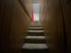 A stairway features wood paneled walls leading to a carpeted staircase to the next level at 212 South Se Ave, Marietta, GA 30060
