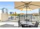 Balcony featuring seating area with umbrella and views of the city skyline at 1280 W Peachtree Nw St # 810, Atlanta, GA 30309