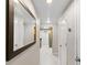 Inviting hallway with neutral tones, large decorative mirror, and tile flooring leading to other living spaces at 1280 W Peachtree Nw St # 810, Atlanta, GA 30309