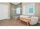 Well-lit bathroom features soaking tub, glass shower and large window at 1436 Belmont Ave, Smyrna, GA 30080