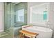 Modern bathroom with a freestanding tub, glass-enclosed shower and a wooden stool at 1436 Belmont Ave, Smyrna, GA 30080