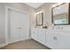 Bright bathroom featuring double sinks, white cabinetry, decorative mirrors and tile floors at 1436 Belmont Ave, Smyrna, GA 30080